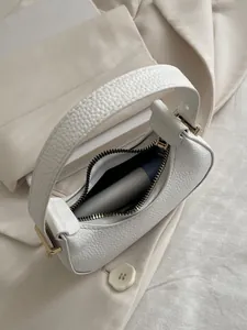 Detail of white lychee pattern mini hobo bag showing interior space for a lipstick