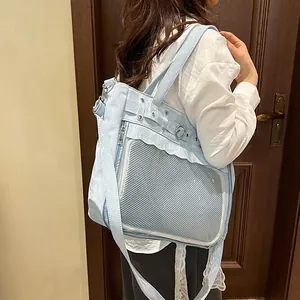 Light blue ita bag with ruffled edges and heart buckle shown on a model side view