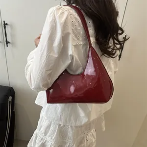 Sac bandoulière demi-lune en cuir verni brillant bordeaux profond pour un look chic