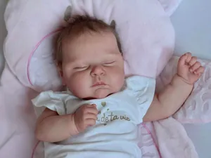 Close-up of a 50cm realistic reborn baby doll with lifelike skin and hand-rooted hair