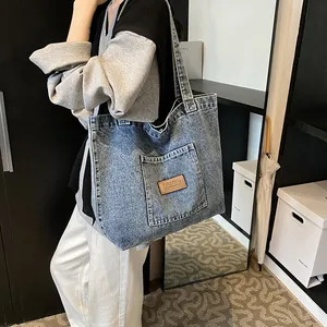 Large capacity washed blue denim tote bag with front pocket for daily casual style