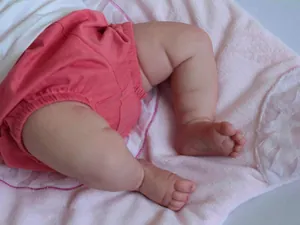 Close-up of realistic newborn skin texture and wrinkles on a handcrafted reborn doll