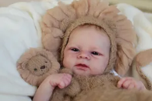 Macro shot of 49cm Reborn Doll with realistic 3D skin and lion-themed knitted outfit