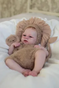 Close-up of handmade lion knit baby outfit featuring mohair mane hat and brown romper