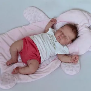 50cm handmade lifelike reborn baby doll in white tee and red shorts on pink mat