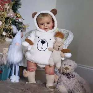 Realistic baby doll Zoe wearing a white plush bear hoodie romper with socks and shoes