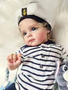 Close-up of lifelike reborn baby boy doll in navy sailor outfit with realistic skin details