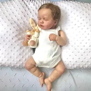 Realistic 49cm reborn baby doll Loulou sleeping in white bodysuit with plush bunny