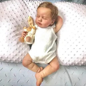 Lifelike 49cm Loulou reborn baby doll with visible veins sleeping on a soft pillow