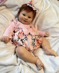 Close-up of 50cm lifelike reborn baby doll Maddie with blue eyes and floral outfit