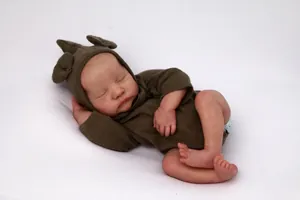 Close-up of lifelike newborn doll skin textures and realistic sleeping baby facial features