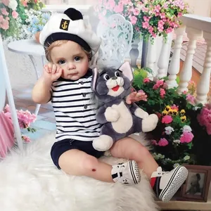 Realistic reborn boy doll Toddler Maggi with blue eyes in a navy outfit and sailor hat