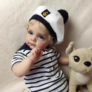 Realistic Reborn Toddler Doll Maggi in sailor outfit with plush dog on soft background