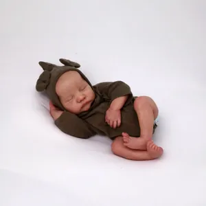Realistic sleeping reborn baby doll Levi wearing an olive green bear-ear romper