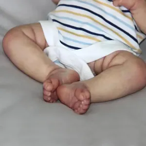 Realistic 49cm Elijah newborn doll featuring 3D painted skin and striped romper