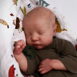 Realistic 49cm reborn baby doll Levi sleeping in green outfit and white swaddle