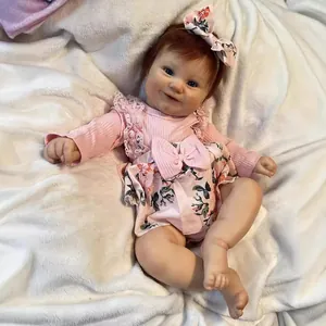 50cm realistic reborn baby doll Maddie in pink floral outfit on white plush blanket
