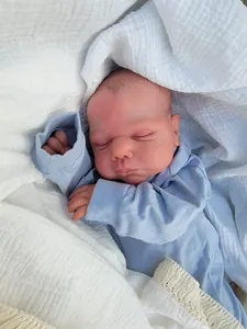 Close-up of 19-inch lifelike reborn baby doll Miley sleeping in blue pajamas