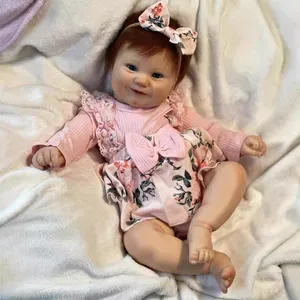 50cm lifelike reborn baby doll Maddie in pink floral outfit on soft plush background