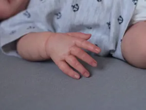 Detailed realistic skin texture and hand wrinkles on a 49cm soft body reborn baby doll