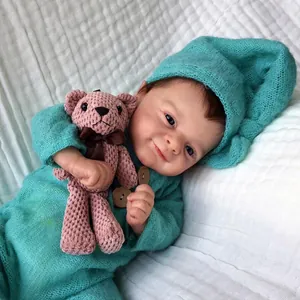 Lifelike 46cm reborn baby doll in teal knit romper with matching hat and pink bear