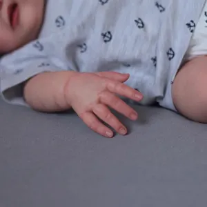 Realistic 49cm reborn baby doll with detailed skin texture and navy anchor print shirt