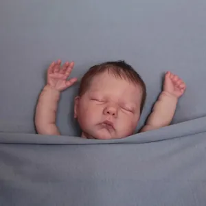 Realistic 49cm soft body reborn baby doll in sleeping pose wrapped in grey fabric