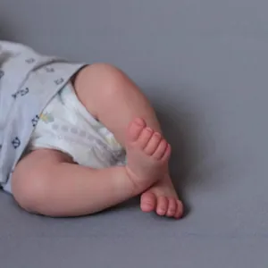 Realistic 49cm reborn baby doll with detailed skin textures and anchor print outfit