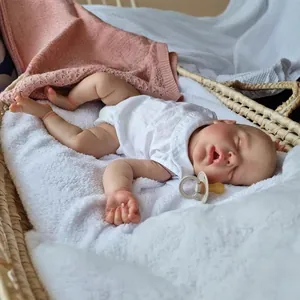 Realistic 22-inch reborn baby doll with 3D skin texture and veins sleeping in a cradle