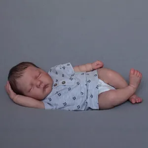 Realistic 49cm reborn baby doll in sleeping pose wearing blue anchor print romper