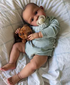 Detail of 20-inch reborn baby doll with realistic 3D skin texture and plush dog toy