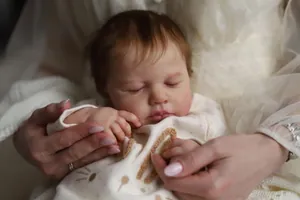 Close-up of sleeping reborn baby LouLou with realistic skin and rabbit ear onesie