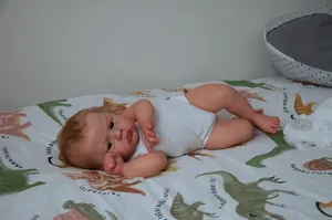 Detailed view of 24 inch lifelike reborn baby doll skin texture and soft brown hair