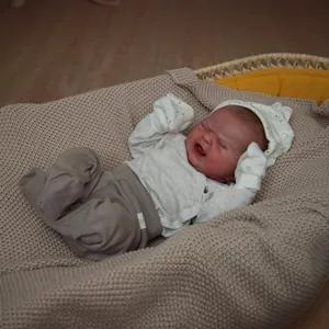 Lifelike 49cm newborn reborn baby doll in crying expression with white knitted outfit