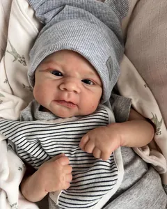 Nahaufnahme der realistischen Babypuppe mit detaillierter 3D-Haut und grauer Strickmütze