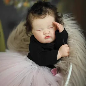 19-inch lifelike reborn baby doll in sleeping pose with tutu skirt and dark curly hair