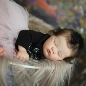Lifelike 19-inch reborn baby doll sleeping in pink tutu skirt and soft plush background