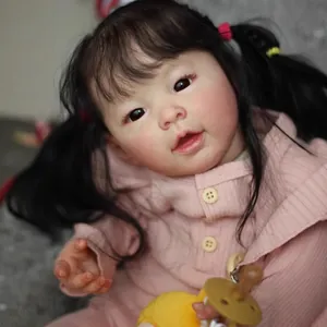 Lifelike 60cm Asian baby doll with black pigtails in a pink hooded knitted sweater