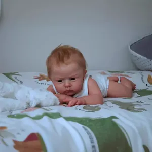 Realistic 24-inch reborn baby doll with lifelike skin and white cotton bodysuit