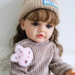 Bambola Reborn Betty da 55cm realistica con capelli castani ricci e occhi blu in maglia