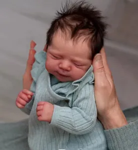 Realistic 19 inch reborn baby doll with detailed skin texture held by hands