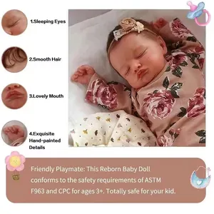 Poupée Rosalie Reborn réaliste de 49cm en barboteuse à fleurs sur coussin blanc