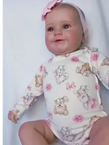 Detailed close-up of reborn baby Maddie doll showing lifelike skin and floral romper