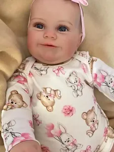 Detailed close-up of Maddie reborn doll's realistic face, blue eyes, and soft skin texture