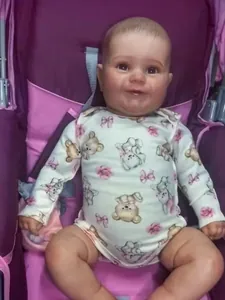 Realistic reborn toddler doll in bear print onesie lying in a pink stroller