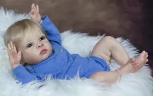 Detailed view of 55cm realistic baby doll with blue eyes and soft blue rompers