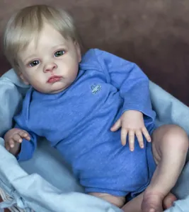 Detailed close-up of a lifelike 55cm baby doll in blue romper resting in a basket