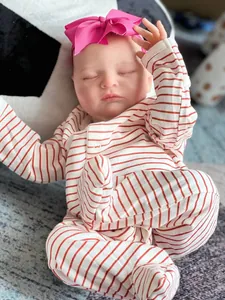 Detailed view of handmade 20 inch reborn doll in striped romper with 3D skin texture