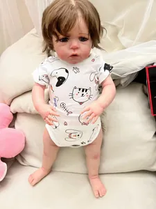 Close-up of 60cm reborn doll features realistic skin and cute cat printed white romper