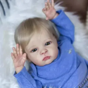 Lifelike 55cm baby doll with realistic skin texture and blonde hair on white plush mat
